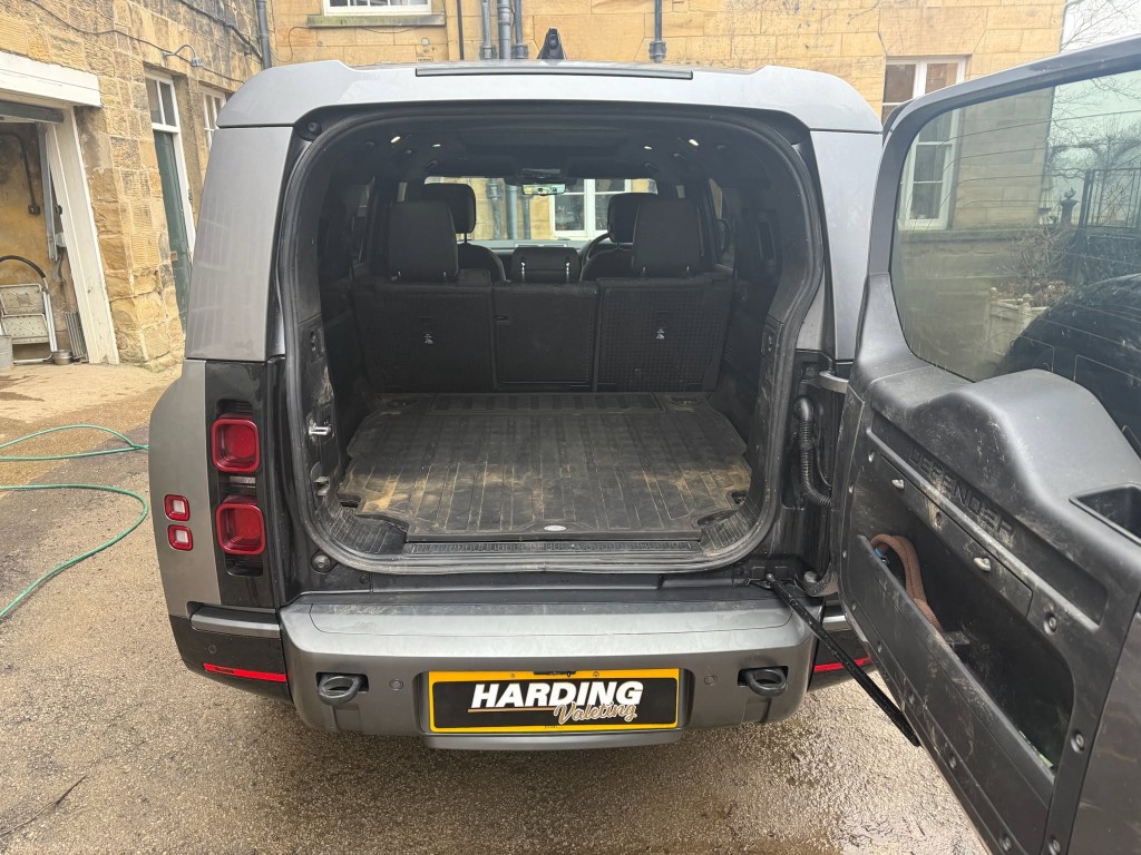 Defender 110 boot before — heavily soiled rubber floor liner with dirt and mud