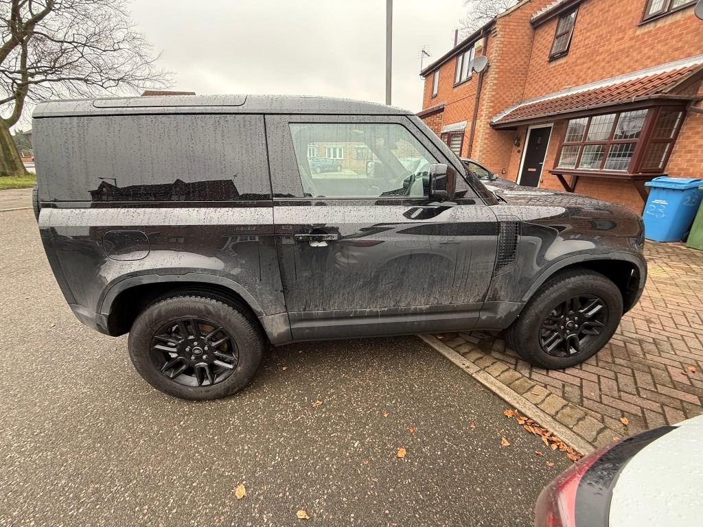 Defender 90 before — dirty side panels with water marks and grime streaks