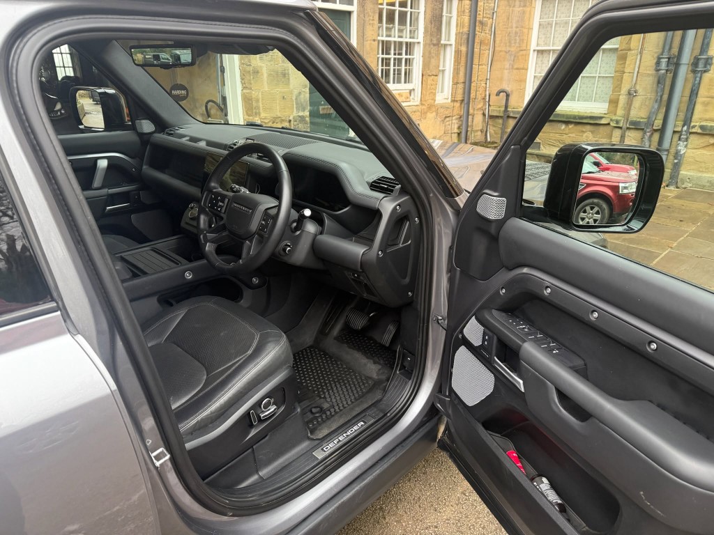 Defender interior after — clean floor mats, spotless door sill and fresh cabin