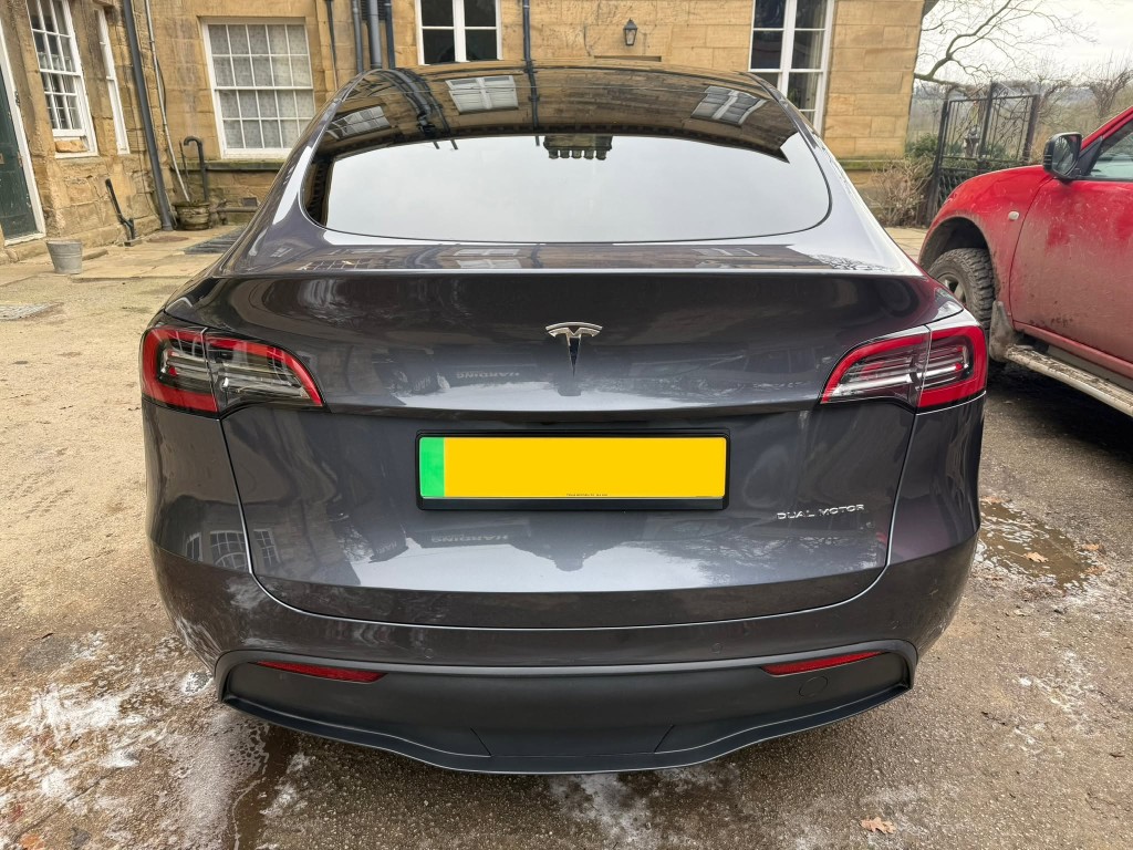 Tesla Model Y after — gloss finish restored, clean panels with clear reflections