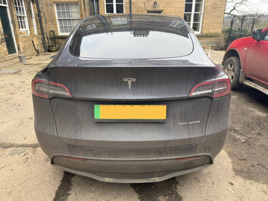 Tesla Model Y before — dusty and dirty rear exterior, dull bodywork